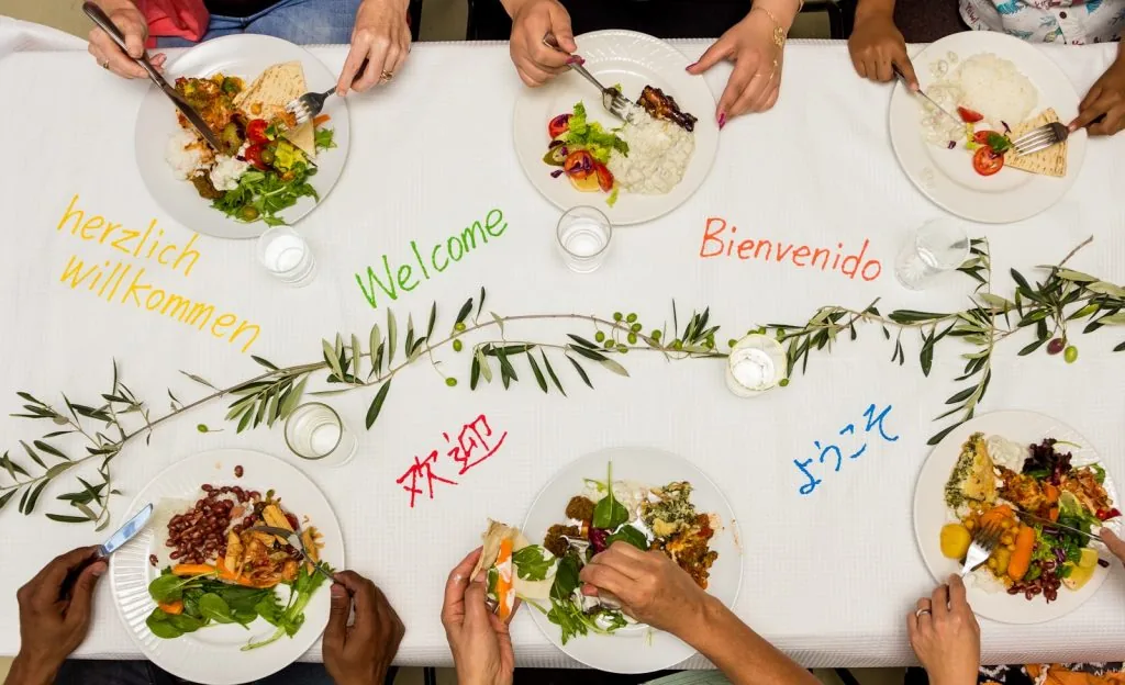 A group of people sitting around a table eating food